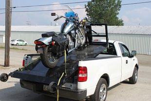 Flatbed tow truck safely transporting a motorcycle in Erie, PA